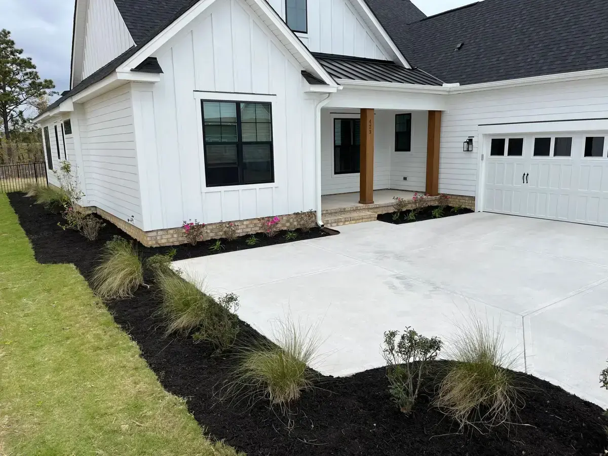 The same beds after fresh mulch, grasses and flowering shrubs went in